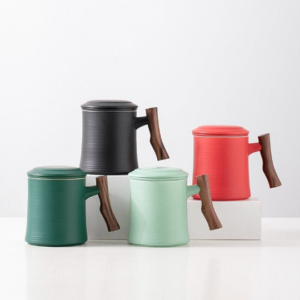 Full side view of handcrafted ceramic tea mug with wooden handle and infuser