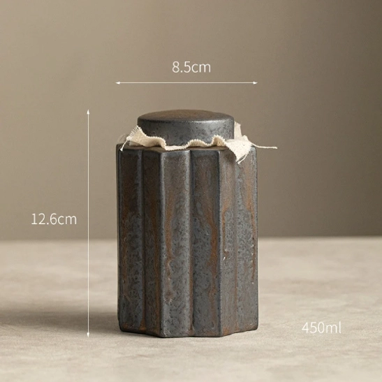 rustic ceramic tea storage canister displayed on a wooden tea table