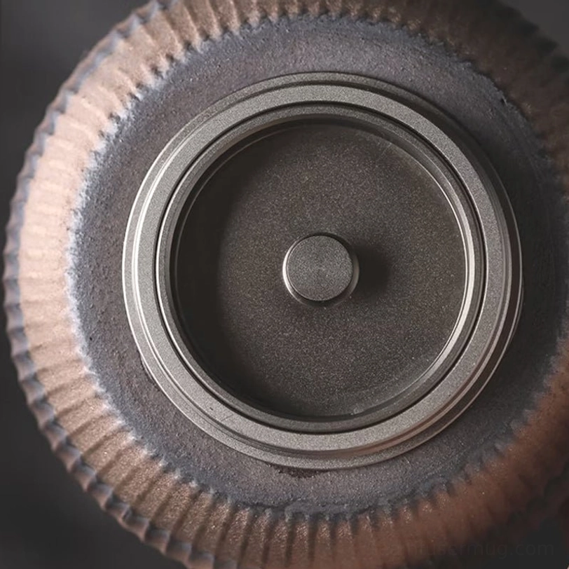 ceramic tea storage canister displayed on wooden tea table