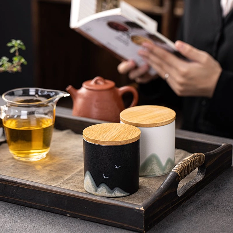 size comparison of compact ceramic tea storage canister next to a hand