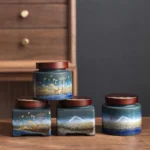 collection of ceramic chinese tea storage canisters with wood lids