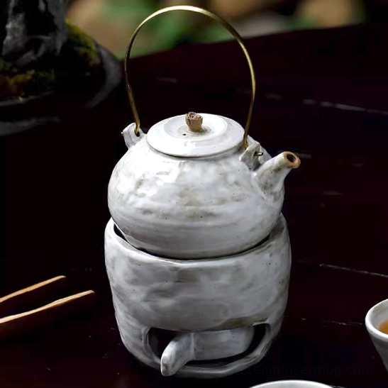 Jingdezhen ceramic teapot and warmer set on wooden table for product display