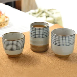 collection of three checkered japanese ceramic tea cups different sizes