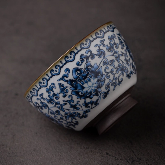 Side view of traditional Chinese porcelain tea cup with blue lotus pattern
