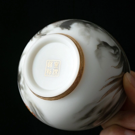Top view of Chinese dragon tea cup showing golden fu character at bottom