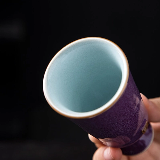 Close up of the gold rim on Chinese high foot ceramic tea cup