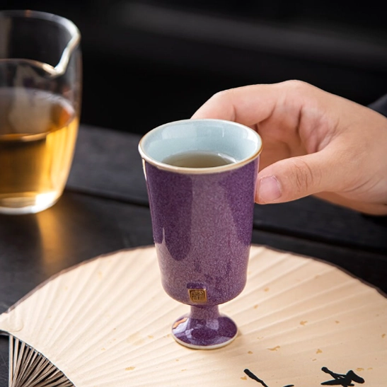 Chinese high foot tea cup placed on wooden tea table