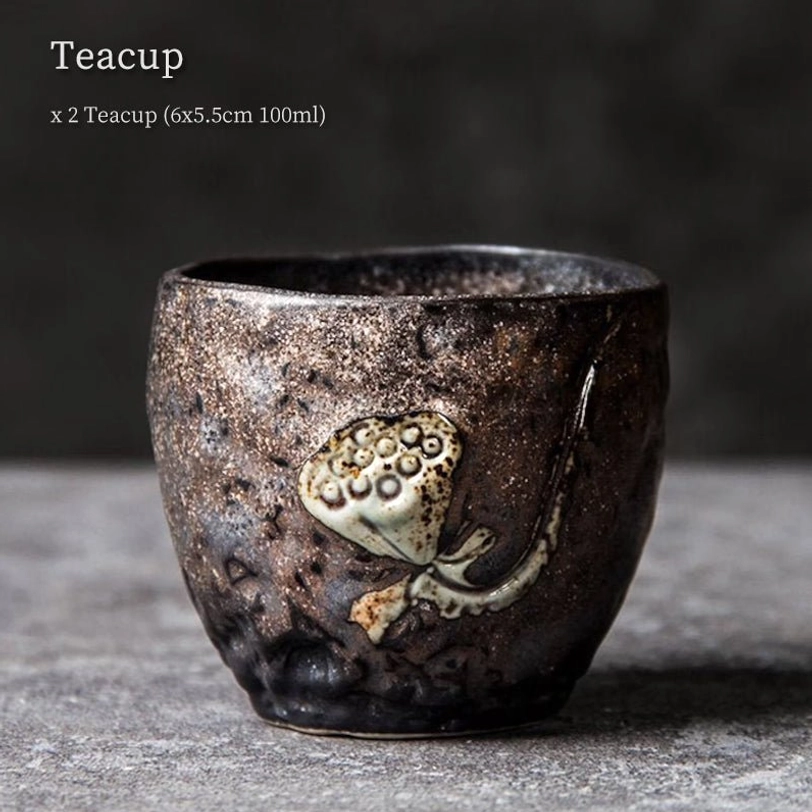 Close up of 3D lotus relief on rustic Chinese clay tea cup