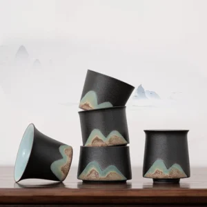 collection of mountain landscape ceramic chinese tea cups on wooden table