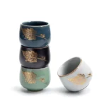 side view of gold insect leaf pattern chinese porcelain tea cup