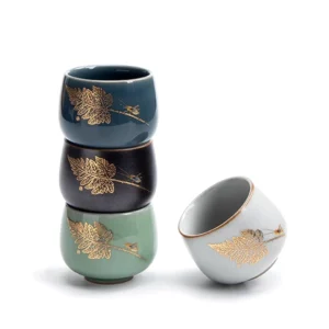 side view of gold insect leaf pattern chinese porcelain tea cup