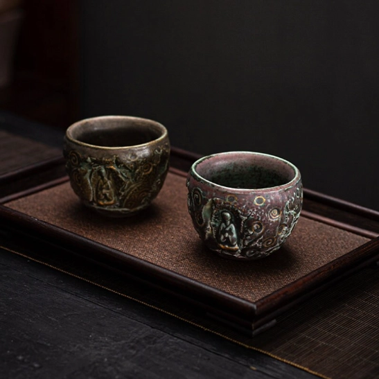 Chinese tea cup with embossed Buddha and gold accent detail