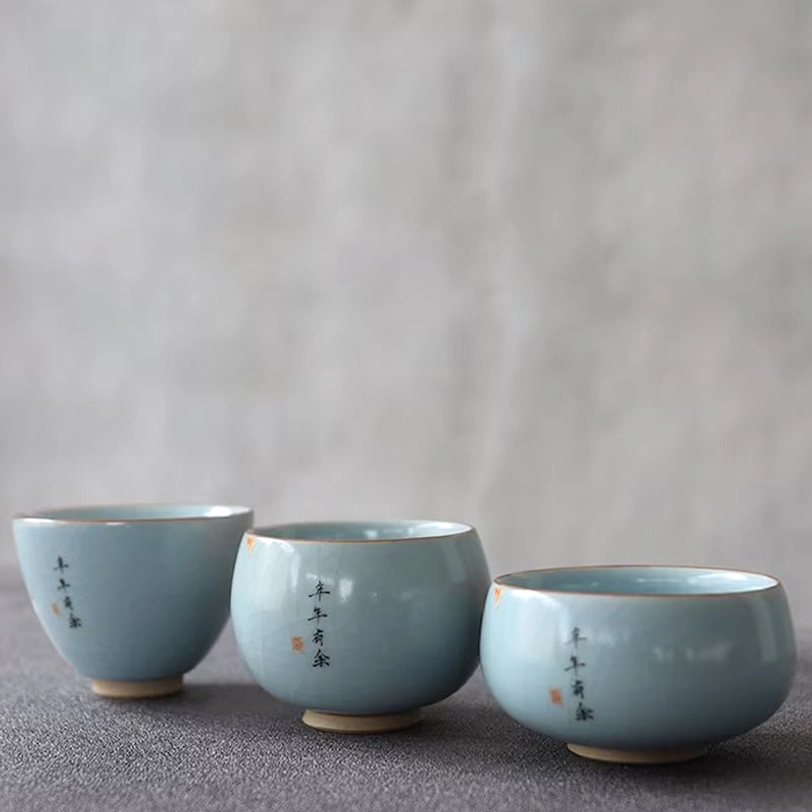 close up of nian nian you yu koi pattern on porcelain tea cup