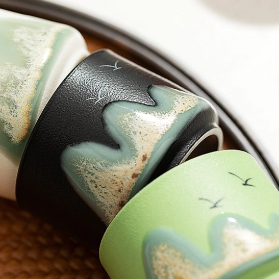 Mountain and bird motif on 70ml Chinese ceramic tea cup close up