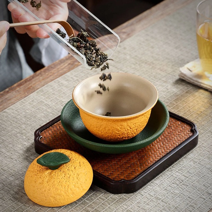 close up of citrus texture on orange ceramic gaiwan tea cup
