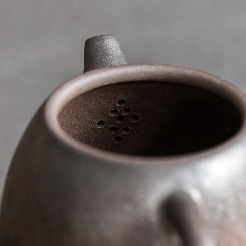 close up of built-in filter holes on 160ml bronze ceramic teapot with infuser