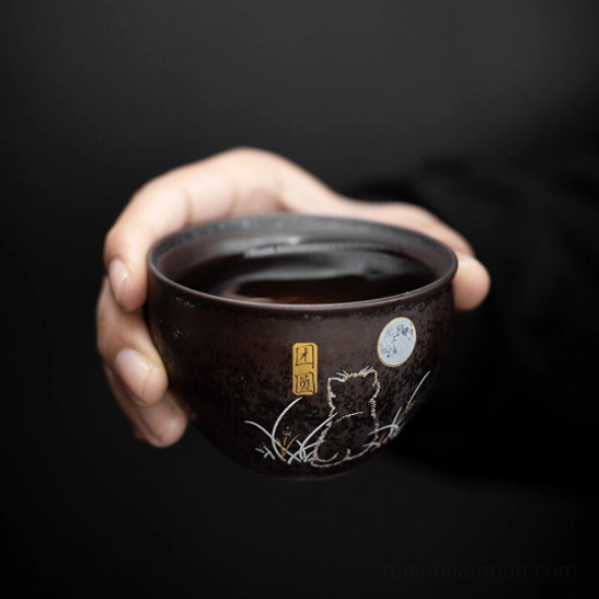 Close up of cat and moon line art pattern on travel tea set ceramic