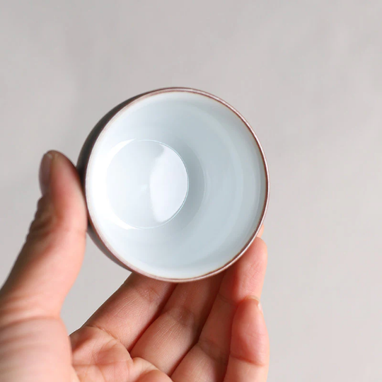 close up of ceramic tea bowl rim showing delicate brown edge detailing