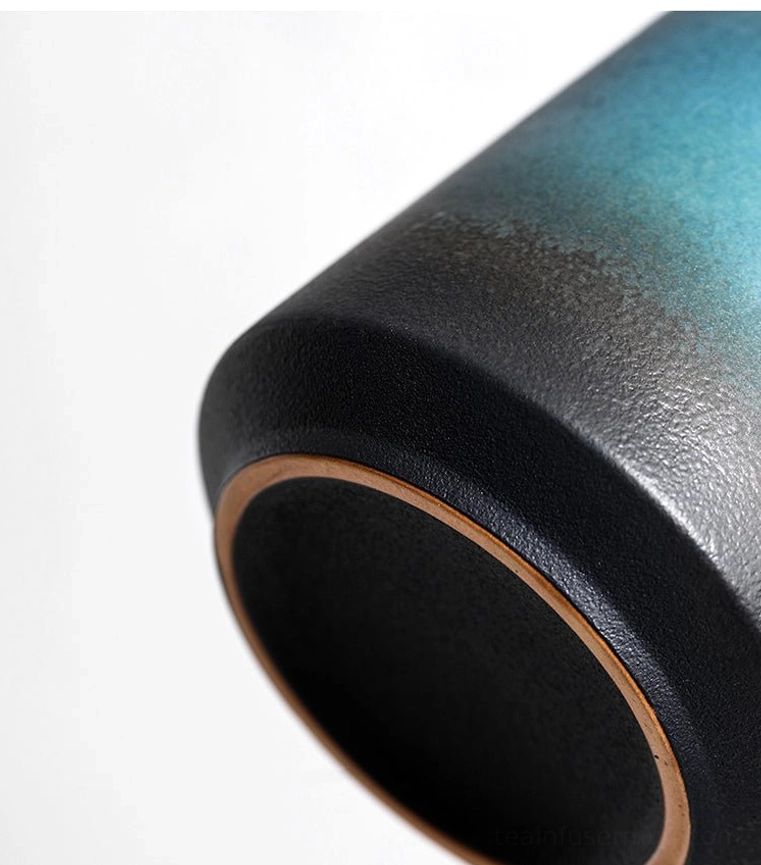 close up of cool-touch solid dark wood handle on ceramic tea infuser mug