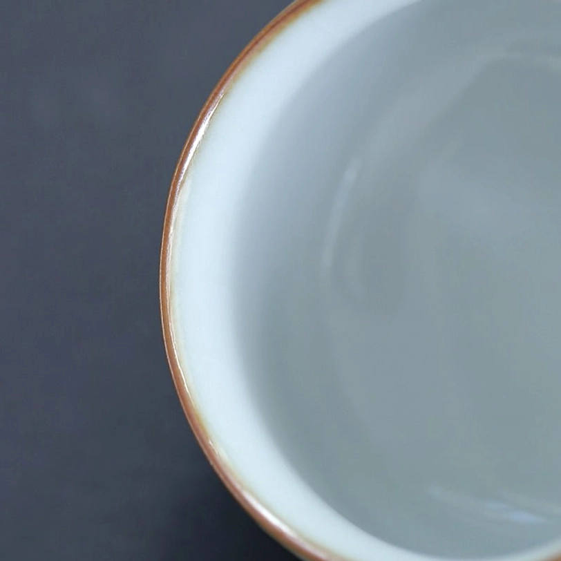 close up of gold rim and crackle glaze texture of cat tea cup