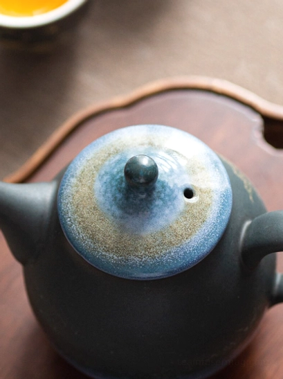 close up of golden deer pattern on starry sky ceramic teapot