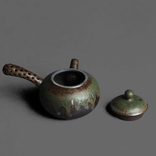 Close up of hollowed镂空 side handle on ceramic Kyusu teapot