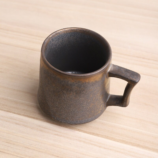 close up of unique kiln varied vintage glaze on ceramic tea mug