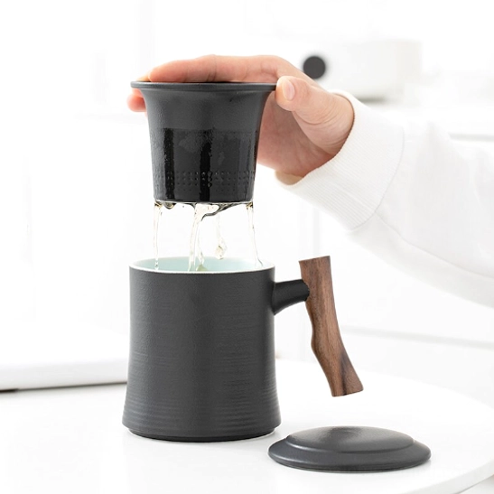 Close up view of natural wooden handle on ceramic tea mug