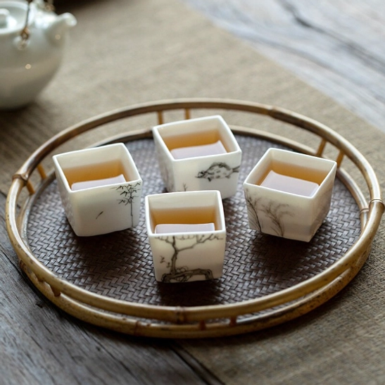 Close up of the smooth glazed rim of a 50ml square Chinese ceramic tea cup