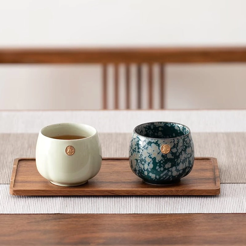 close up of xi happiness metallic emblem on chinese ceramic tea cup