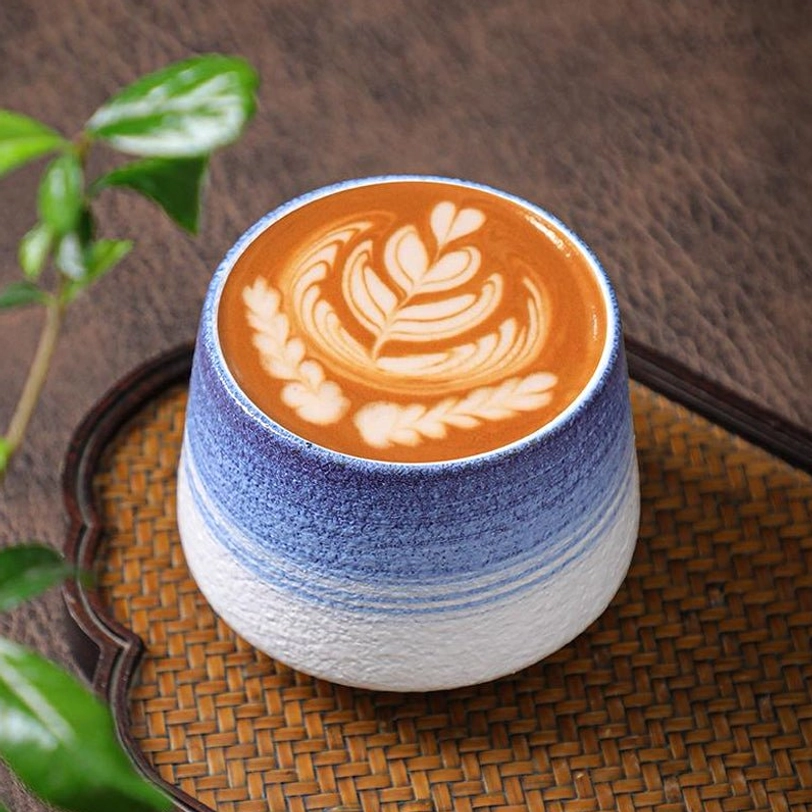 coffee latte with heart latte art in glazed ceramic tea cup