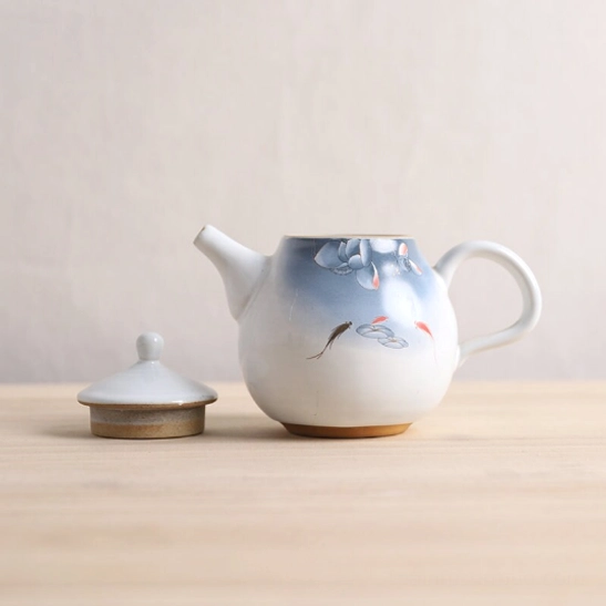 Compact 250ml teapot with infuser held in hand for size reference