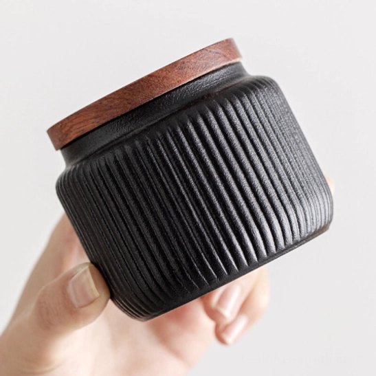 compact ceramic tea canister size comparison next to a tea scoop