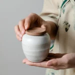 full product view of compact white ceramic tea storage canister with brown lid