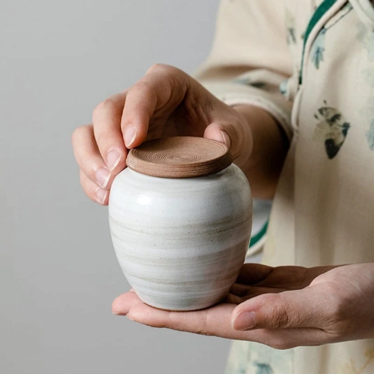 full product view of compact white ceramic tea storage canister with brown lid