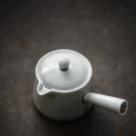 full light gray ceramic kyusu tea set on wooden background