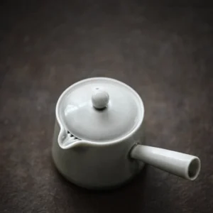 full light gray ceramic kyusu tea set on wooden background