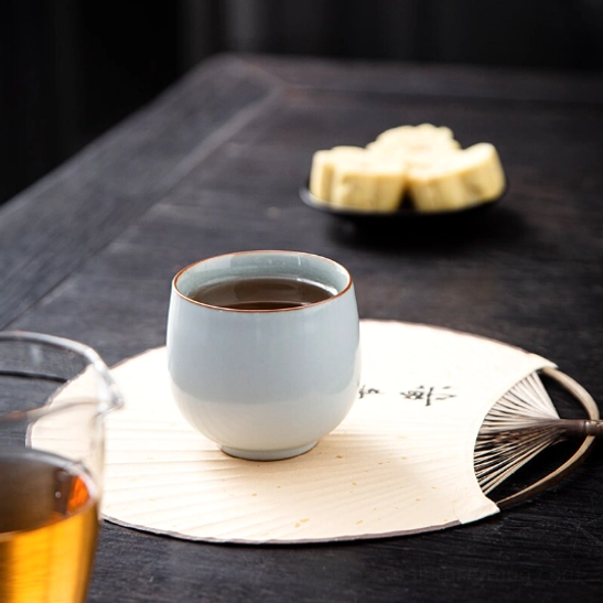 top view of cyan Chinese porcelain tea cup showing crackle glaze inner surface