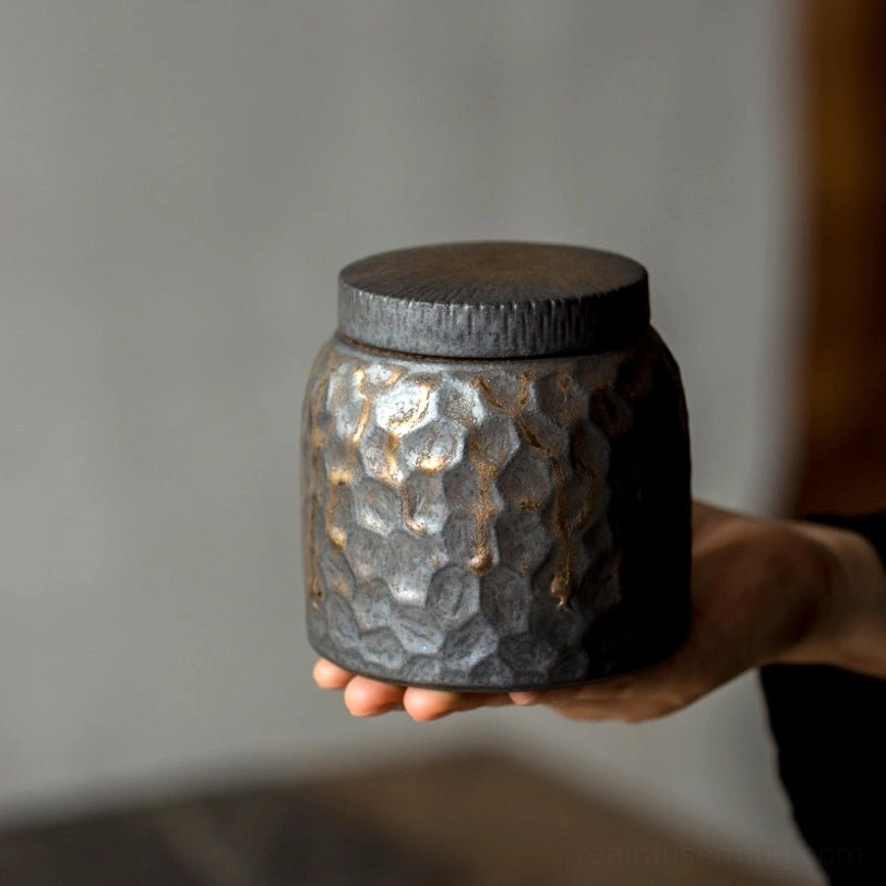 dark gray ceramic tea storage jar with hammered texture