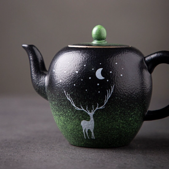 deer motif ceramic teapot side view showing night sky star pattern