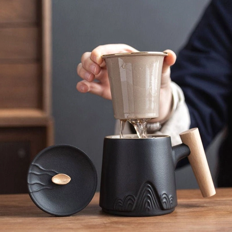 close up of embossed chinese landscape relief on tea infuser mug base