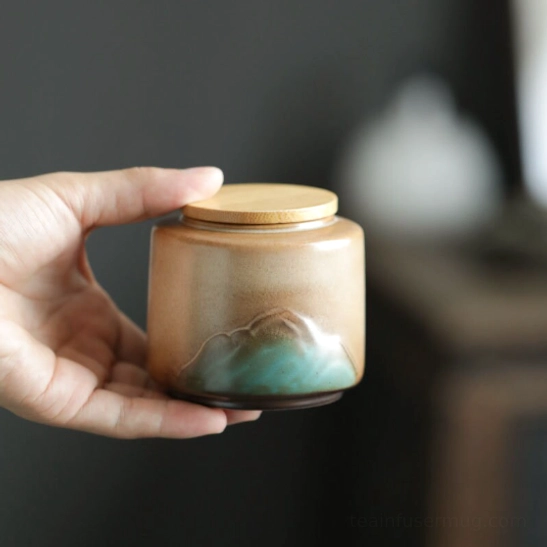 close up of embossed mountain pattern on ceramic tea canister