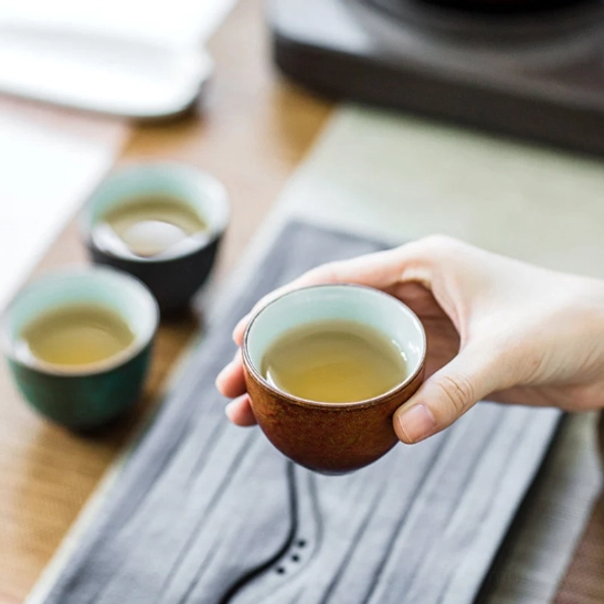 ergonomic chinese ceramic tea cup held in hand