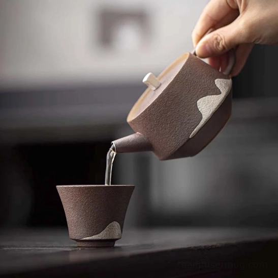 faraway mountain ceramic teapot displayed on wooden tea table