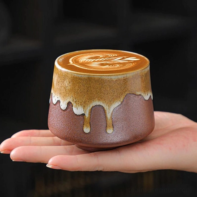 flow glazed brown large tea cup held in hand