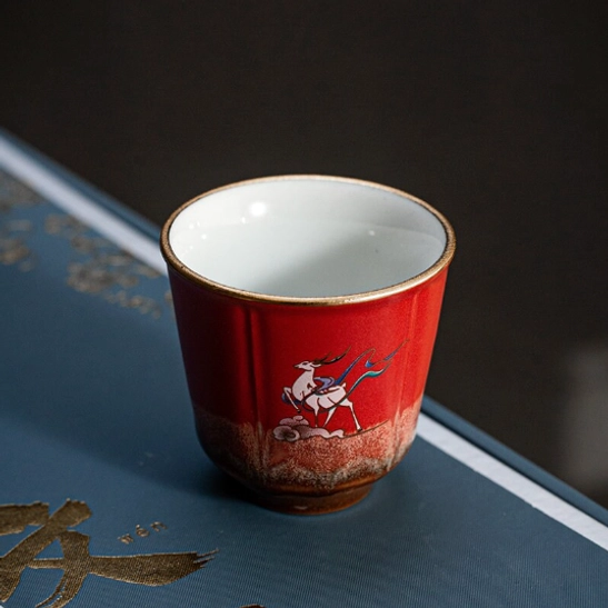 four different colored chinese deer tea cups arranged together close up