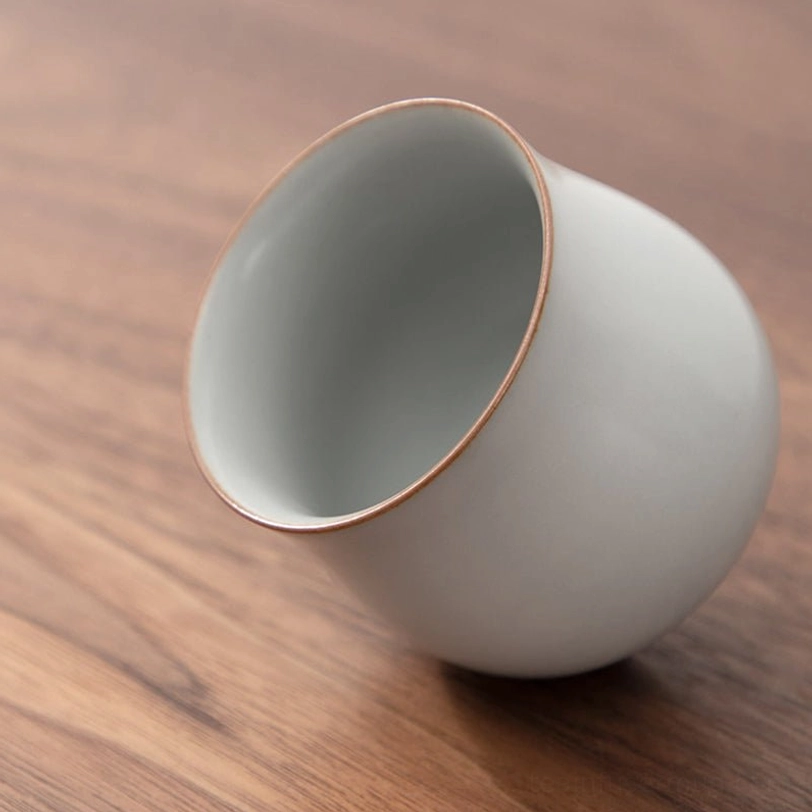 four color vintage porcelain tea cups set on tea tray