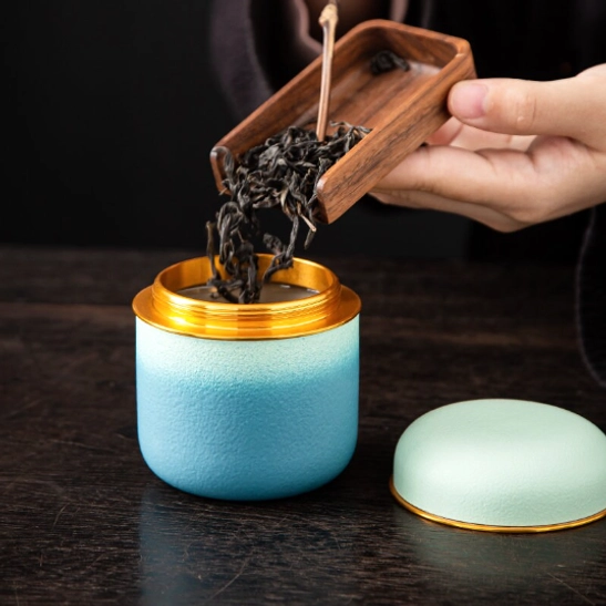 four gradient tea storage canisters arranged on wood background