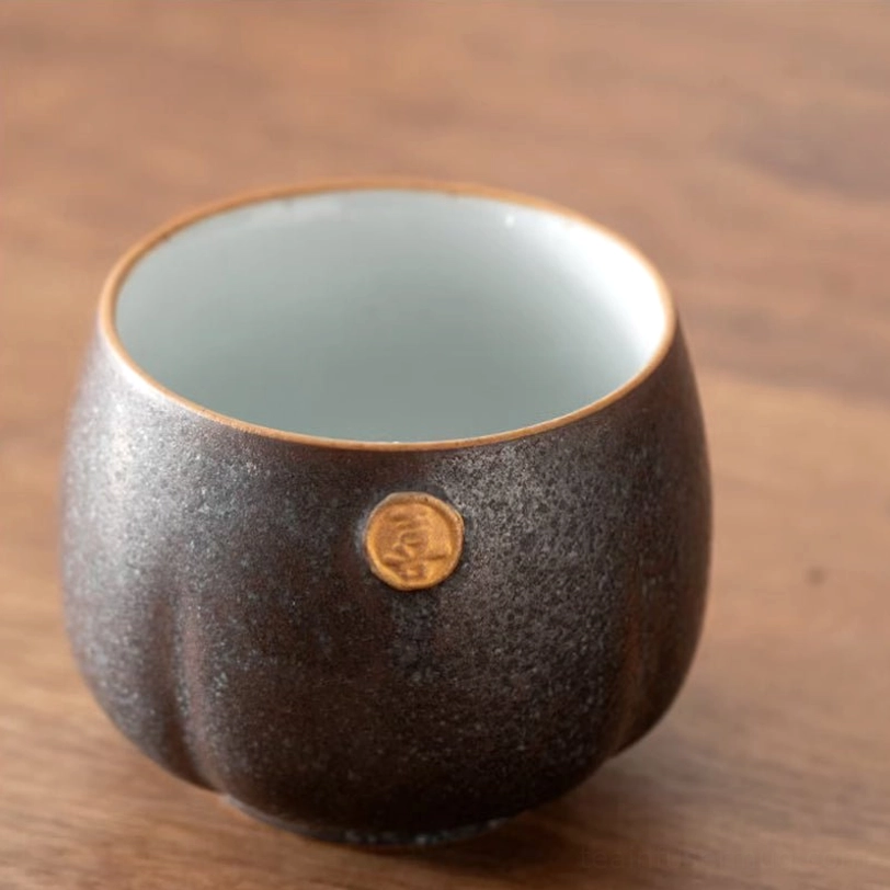 four unique mixed glaze chinese tea cups arranged outside packaging