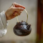 Full set of black ceramic teapot with infuser and matching tea warmer stove